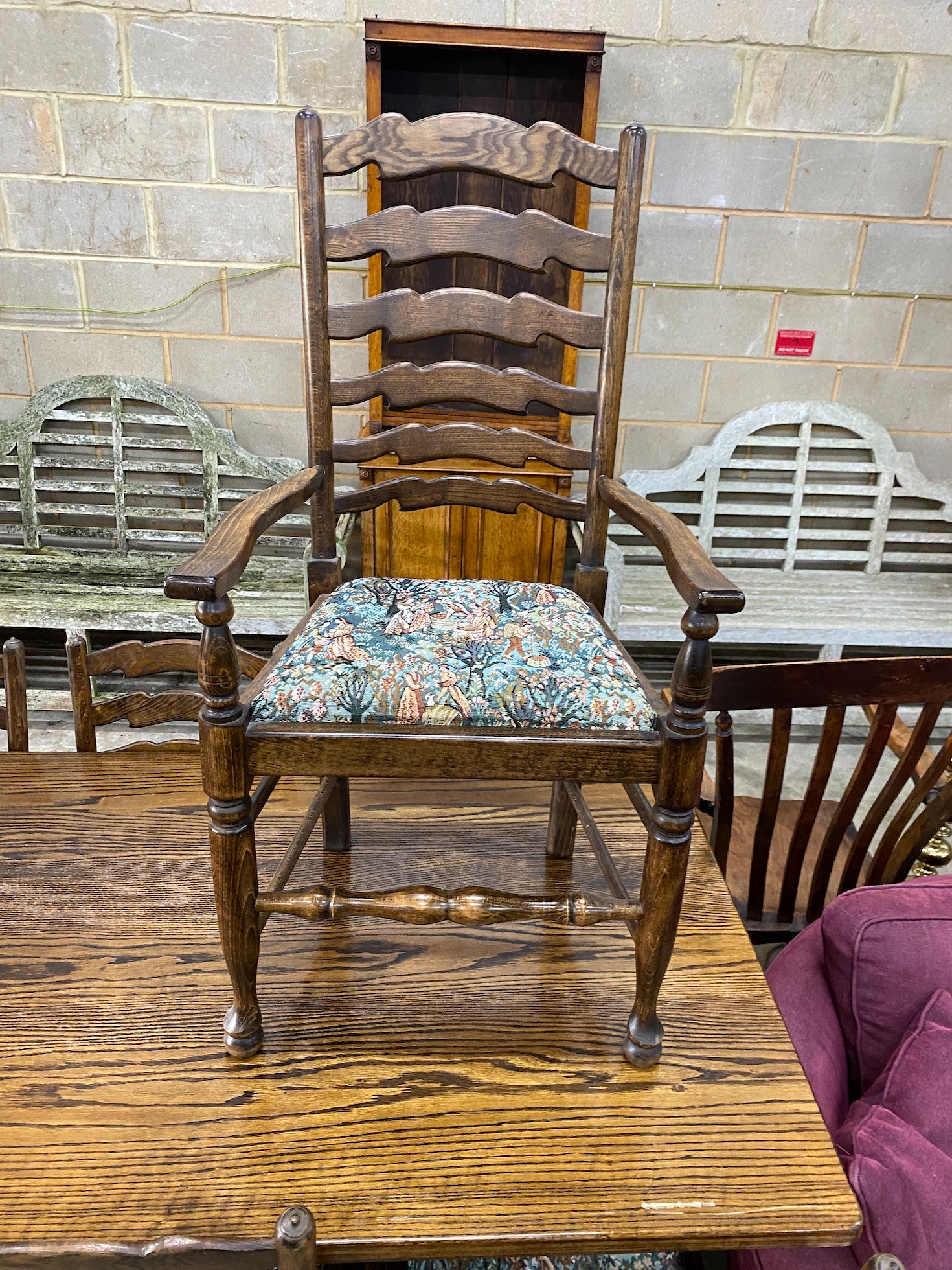An 18th century style rectangular oak refectory dining table, length 210cm, depth 92cm, height 76cm together with a set of ten oak and beech ladder back dining chairs (two with arms) *Please note the sale commences at 9a